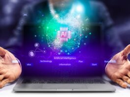 Neon sparkles rise up from a laptop with the floating letters AI