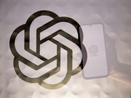 OpenAI logo superimposed on a reflection of a phone