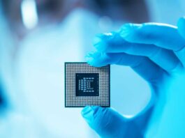 The scientist works in a modern scientific laboratory for the research and development of microelectronics and processors. Microprocessor manufacturing worker uses computer technology and equipment.