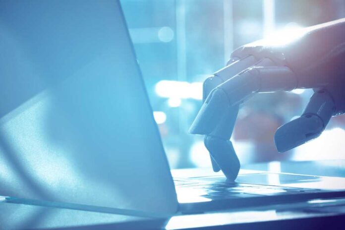 Robot finger point to laptop button with blue tone image. Chat bot , artificial intelligence , robo advisor , robotic concept.