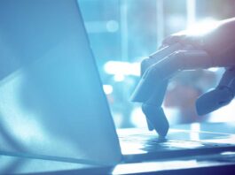 Robot finger point to laptop button with blue tone image. Chat bot , artificial intelligence , robo advisor , robotic concept.