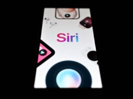 This photograph shows wordmark of Siri, a digital assistant developed by Apple Inc., displayed on a smartphone