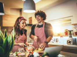 A couple cooking in the kitchent,