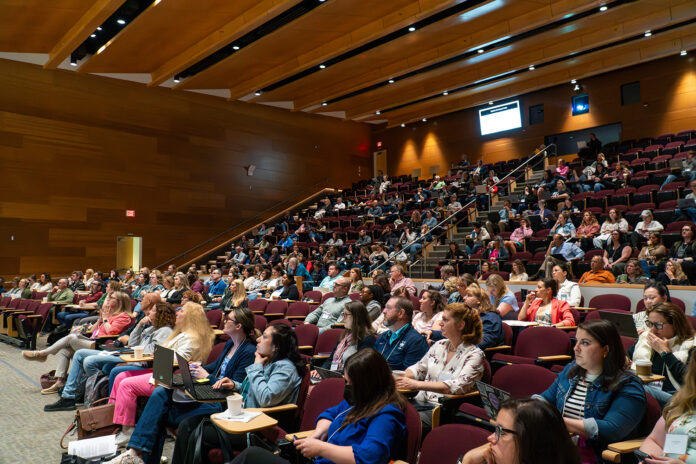 DSC00538-Enhanced-NR_AI_1500x1000.jpg Conference attendees listen to presenters during Teaching and Learning with Technology conference.