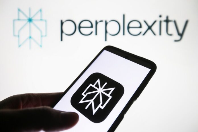 GettyImages-1917904267.jpg Perplexity AI logo is seen on a smartphone and on a PC screen.