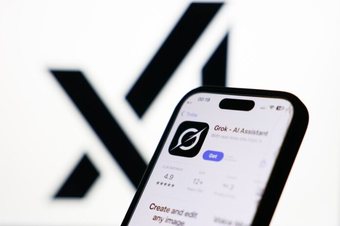 GettyImages-2223576505.jpg xAI logo displayed on a screen and Grok on App Store displayed on a phone screen