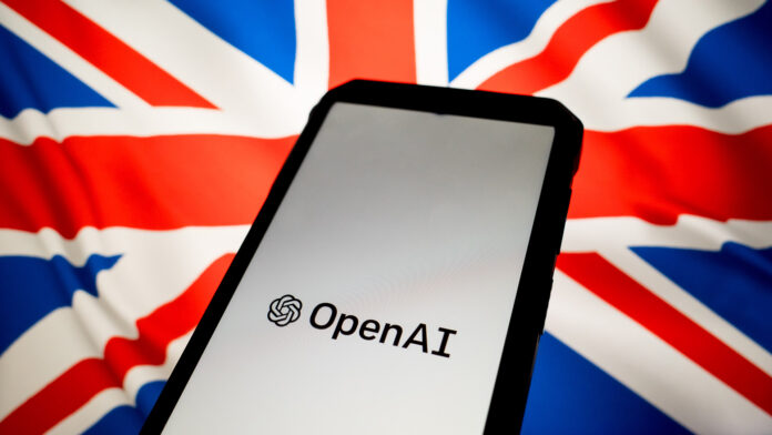 HsJk8EMuYCaaBnYuNhqMqj.jpg The OpenAI logo, shown on a phone against a white background, held in front of the UK flag.