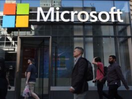 People walk past the front entrance to a Microsoft office building on 8th Avenue on June 24, 2025, in New York City.
