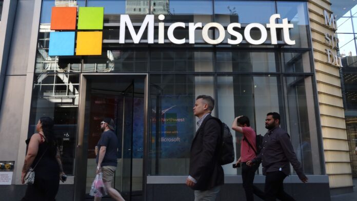 XSuj4Y8LNBVBpRjgDr9uR4.jpg People walk past the front entrance to a Microsoft office building on 8th Avenue on June 24, 2025, in New York City.