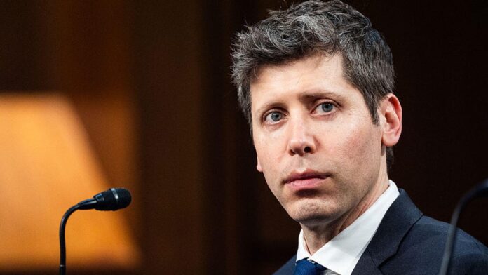 gettyimages-2218523666.jpg Sam Altman, a white man with graying dark hair, sits in front of a microphone.