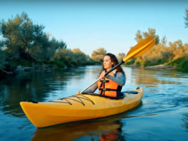 AI-generated image of a woman paddling a kayak on a river