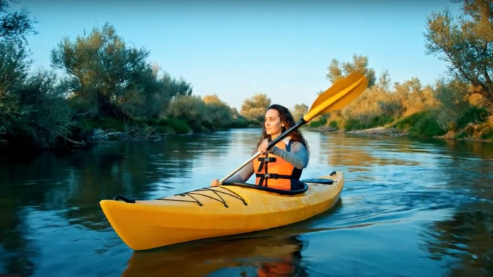 google-veo-3-kayak-on-river.png AI-generated image of a woman paddling a kayak on a river