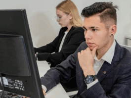 Students in front of computer in classroom