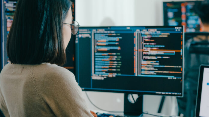 Group Asia Male, Female Freelance Typing Write Prompt Ai Bot It App Smart Program Nomad, Video Game, Terminal With Coding Language, User Interface, Designer, Big Data Center On Desktop Computer.