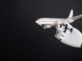 Robotic hand holding airplane model. Integration of robotics and automation in aviation, modernization of flight control technologies