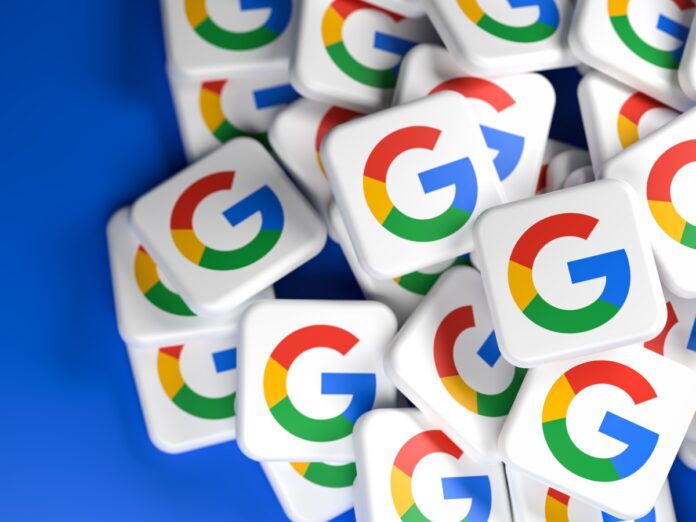 The Google logo on white tiles against a blue background.