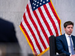 Sam Altman in front of the American flag