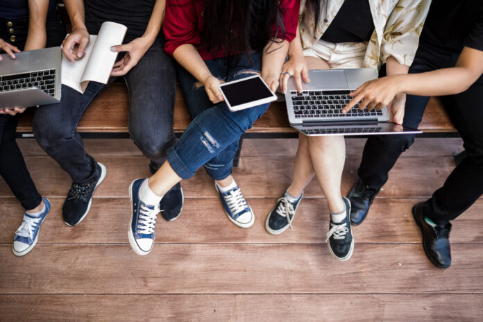 back-to-school image of students on gadgets