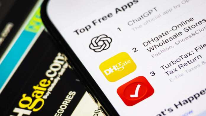 CHONGQING, CHINA - APRIL 15: In this photo illustration, the DHgate app is shown ranked second on the Top Free Apps chart in the Apple App Store, just below ChatGPT and above TurboTax, while part of the DHgate website interface is visible in the background, on April 15, 2025 in Chongqing, China. The Trump trade war has gone viral on TikTok, pushing a Chinese e-commerce app, DHgate, to the No. 2 spot on the US App Store&#039;s free iPhone apps chart. (Photo by Cheng Xin/Getty Images)