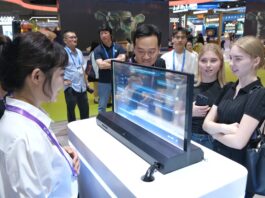 People test out a real-time translation transparent screen at a global tech exhibition in China