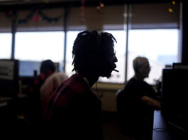 Customer Experience Representative Rico Thomas takes calls at an Alorica center, Monday, Aug. 19, 2024, in San Antonio. (AP Photo/Eric Gay)