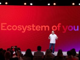 Cristiano Amon on stage with &quot;Ecosystem of you&quot; on a screen