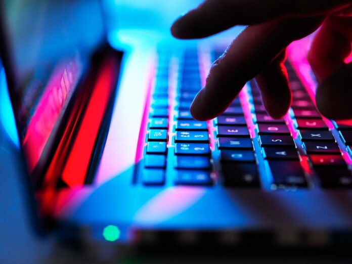 GettyImages-1175885065.jpg Man typing at his laptop computer at night