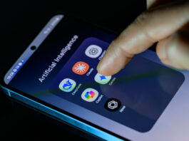 A photo of someone's smartphone with a folder full of AI apps: DeepSeek, Claude, ChatGPT, Copilot, Gemini, AI Photo, and Nova.