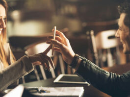 A man and a woman on a date looking at a phone