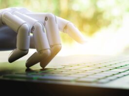 An image of a robot hand typing on a keyboard gettyimages-1065011316