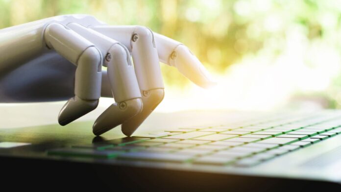 gettyimages-1065011316.jpg An image of a robot hand typing on a keyboard gettyimages-1065011316