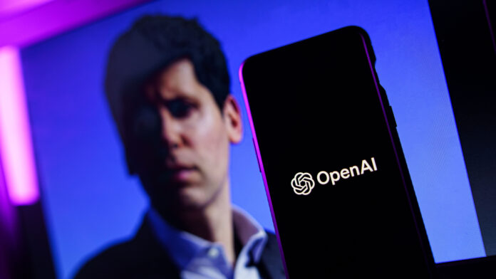 moLABwiduyYGQ7USm7KjzR.jpg Sam Altman and a smartphone.