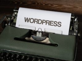 a close up of a typewriter with the word wordpress printed on it