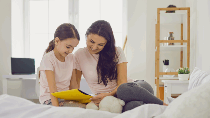 mother and child reading a book together on a bed