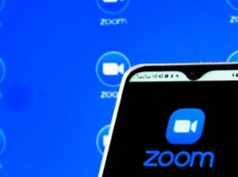 a Zoom Video Communications, Inc. logo is seen displayed on a smartphone screen