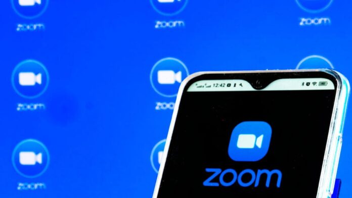 a Zoom Video Communications, Inc. logo is seen displayed on a smartphone screen