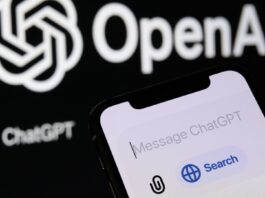 A studio image shows a phone with the new ChatGPT ''Search'' feature, while the OpenAI logo is displayed in the background.