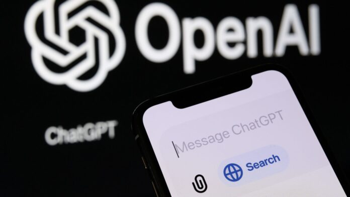 A studio image shows a phone with the new ChatGPT &#039;&#039;Search&#039;&#039; feature, while the OpenAI logo is displayed in the background.