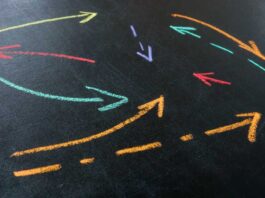 Abstract arrows drawn with colored chalk as a concept of interaction and complex relationships in a company.