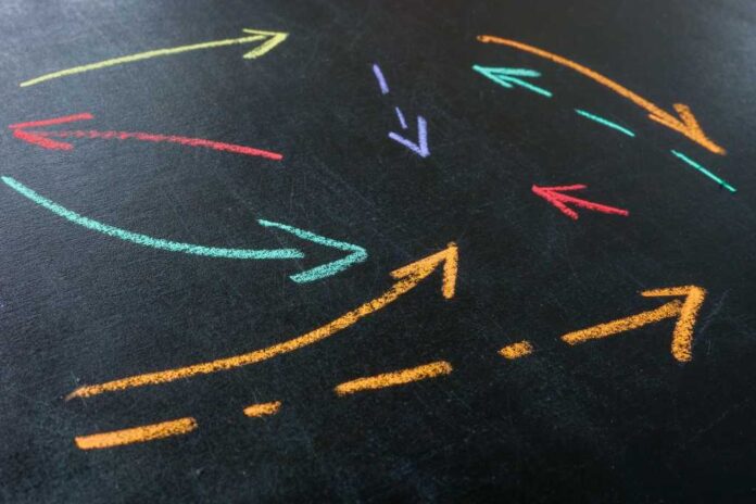 4069808-0-03584100-1760000508-shutterstock_2476700741.jpg Abstract arrows drawn with colored chalk as a concept of interaction and complex relationships in a company.