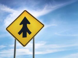 Merge, merger; road sign with blue-sky background