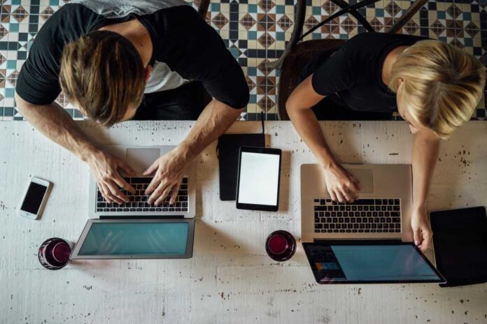 4078662-0-62826500-1761307505-shutterstock_323566982.jpg Coworkers using Mac laptops shot from above
