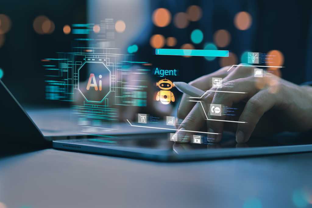 4078869-0-21203000-1761642124-shutterstock_2585278531.jpg A person at a laptop with a stylus and visual overlay suggestive of AI agent development.