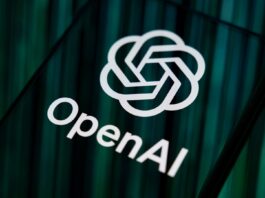 Close-up image of OpenAI logo and branding displayed on a smartphone screen. 