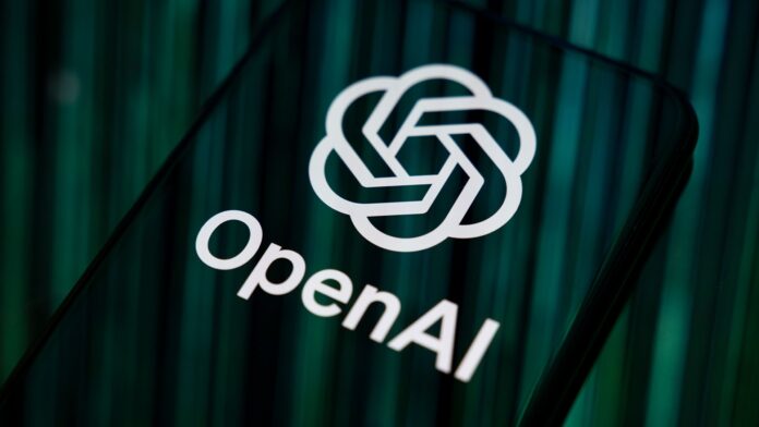 8aKDCf5QfKuUVFmUBc3Fgf-1920-80.jpg Close-up image of OpenAI logo and branding displayed on a smartphone screen.
