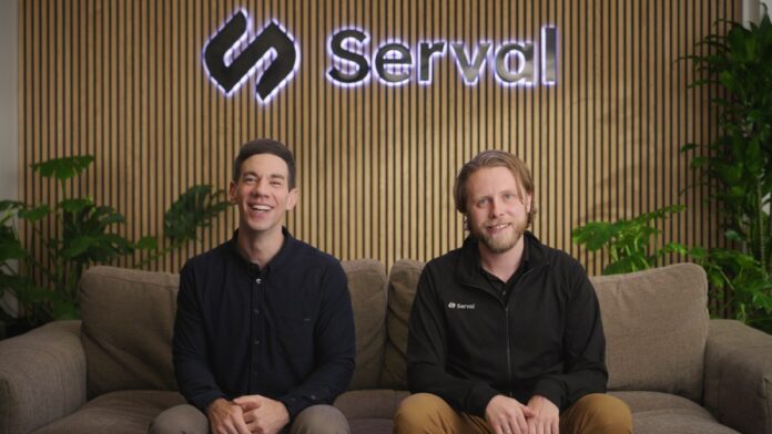 Serval-co-founders.jpg Two caucasian men sit on a couch with a company logo behind them.