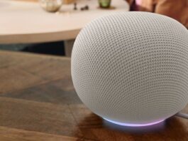 Google Home smart speaker in a porcelain finish on a wooden surface