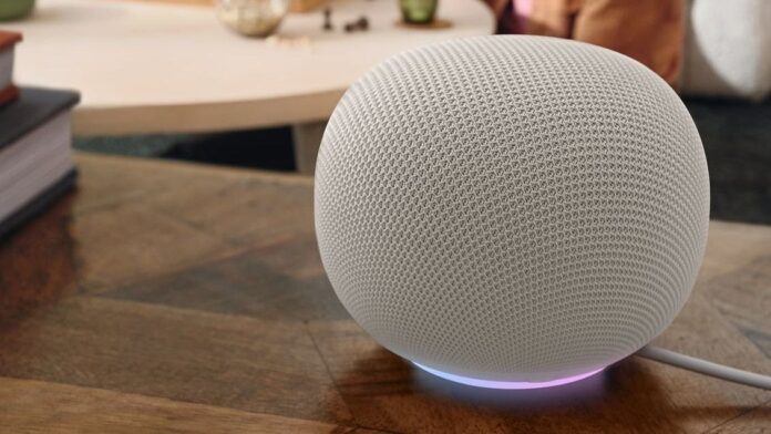 Google Home smart speaker in a porcelain finish on a wooden surface