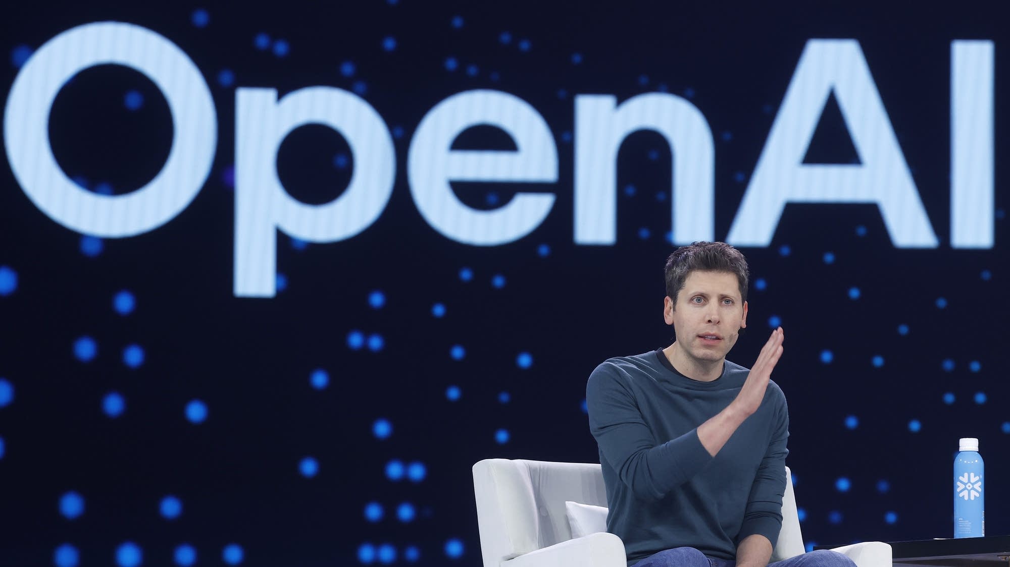 f40569-20251029-open-ai-ceo-sam-altman-sits-and-speaks-in-a-white-chair-in-front-of-text-that-reads.jpeg Above, OpenAI CEO Sam Altman in June.