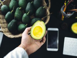 On the desk Table top, smart phone, avocado